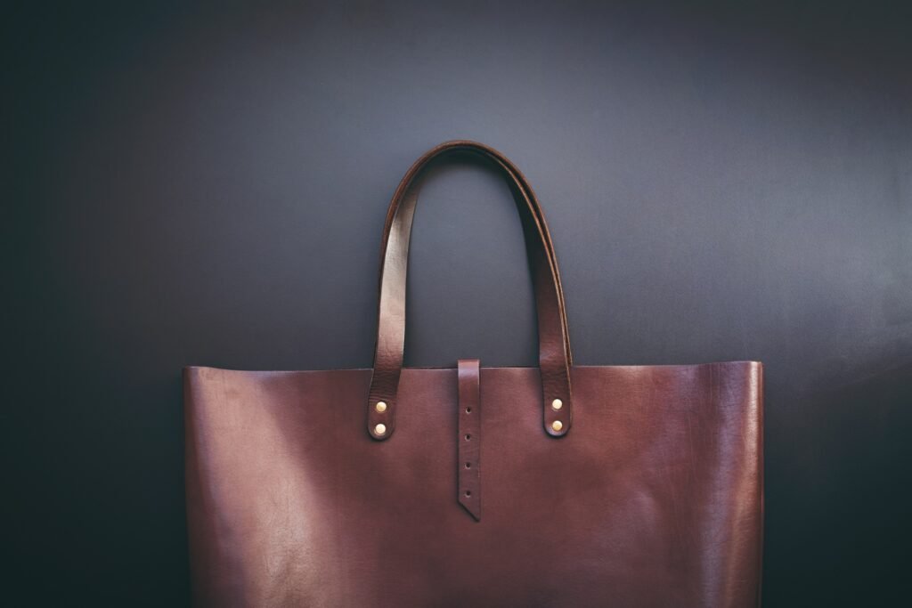 Elegant luxury leather brown bag dark background