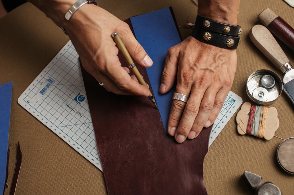 Working process of producing hand made leather wallet in the leather workshop.