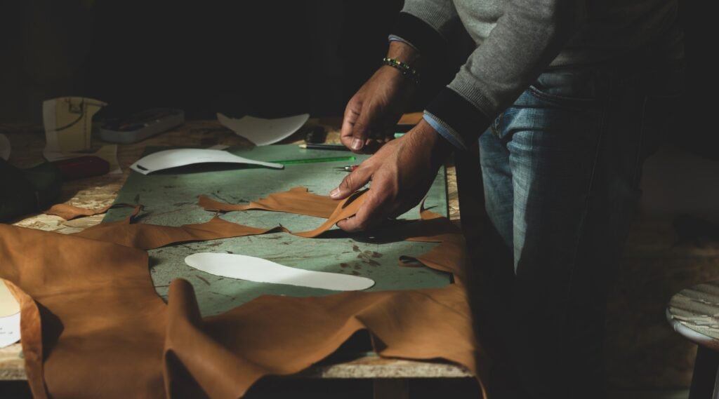 Shoemaker cutting leather